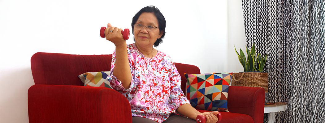 old woman holding dumbbells