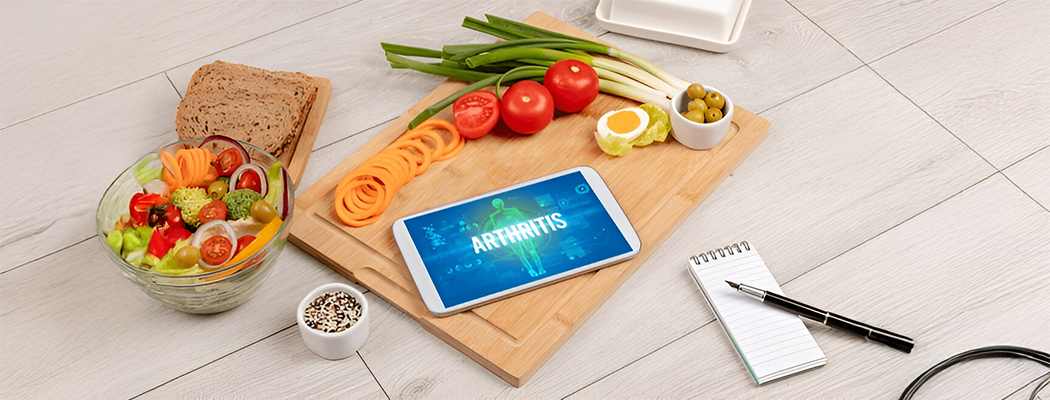 arthritis text on a tablet with foods around